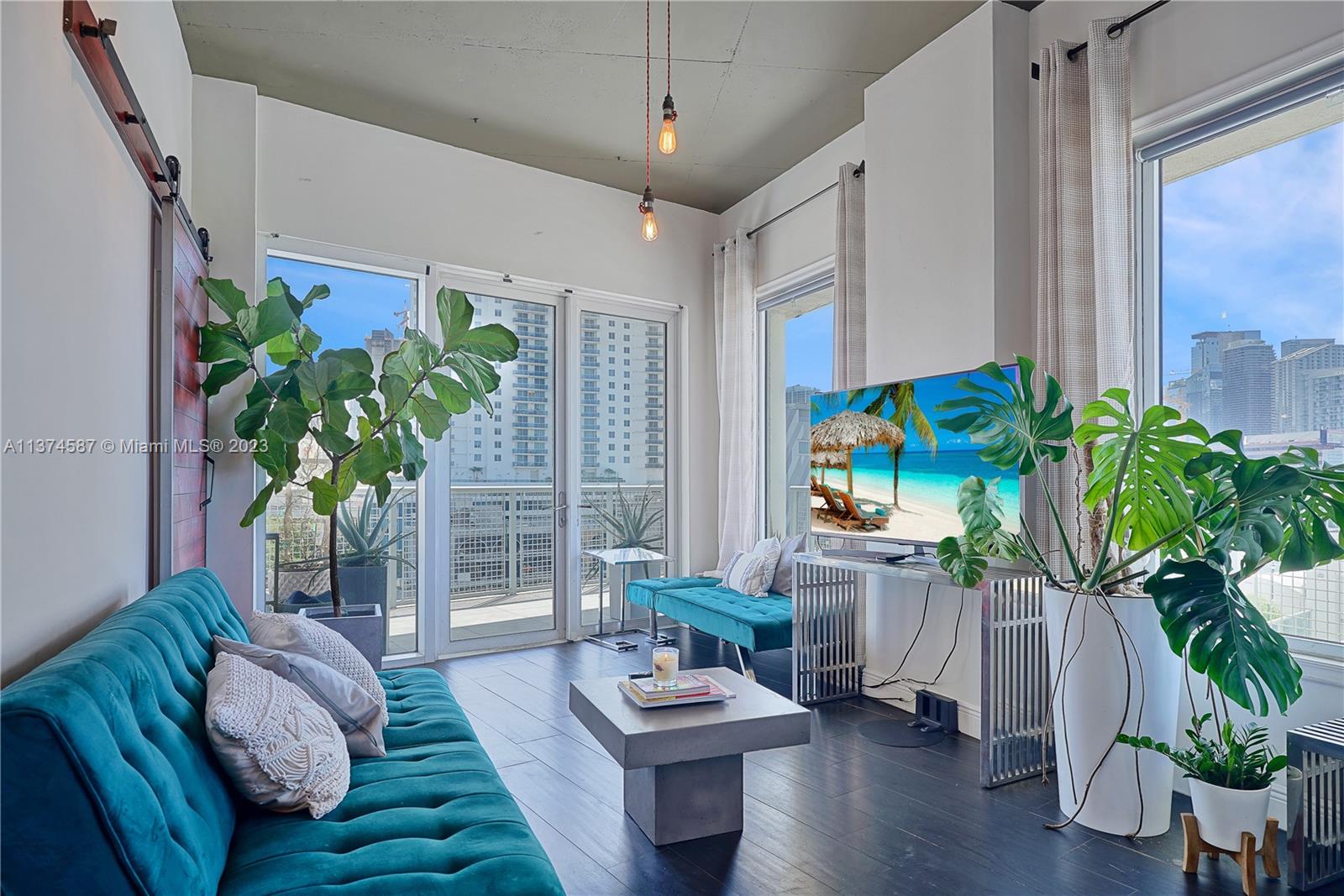 10 Southwest South River Drive, Unit 703 Miami, FL 33130 - Photo 18 of 47 a living room with furniture potted plant and a window
