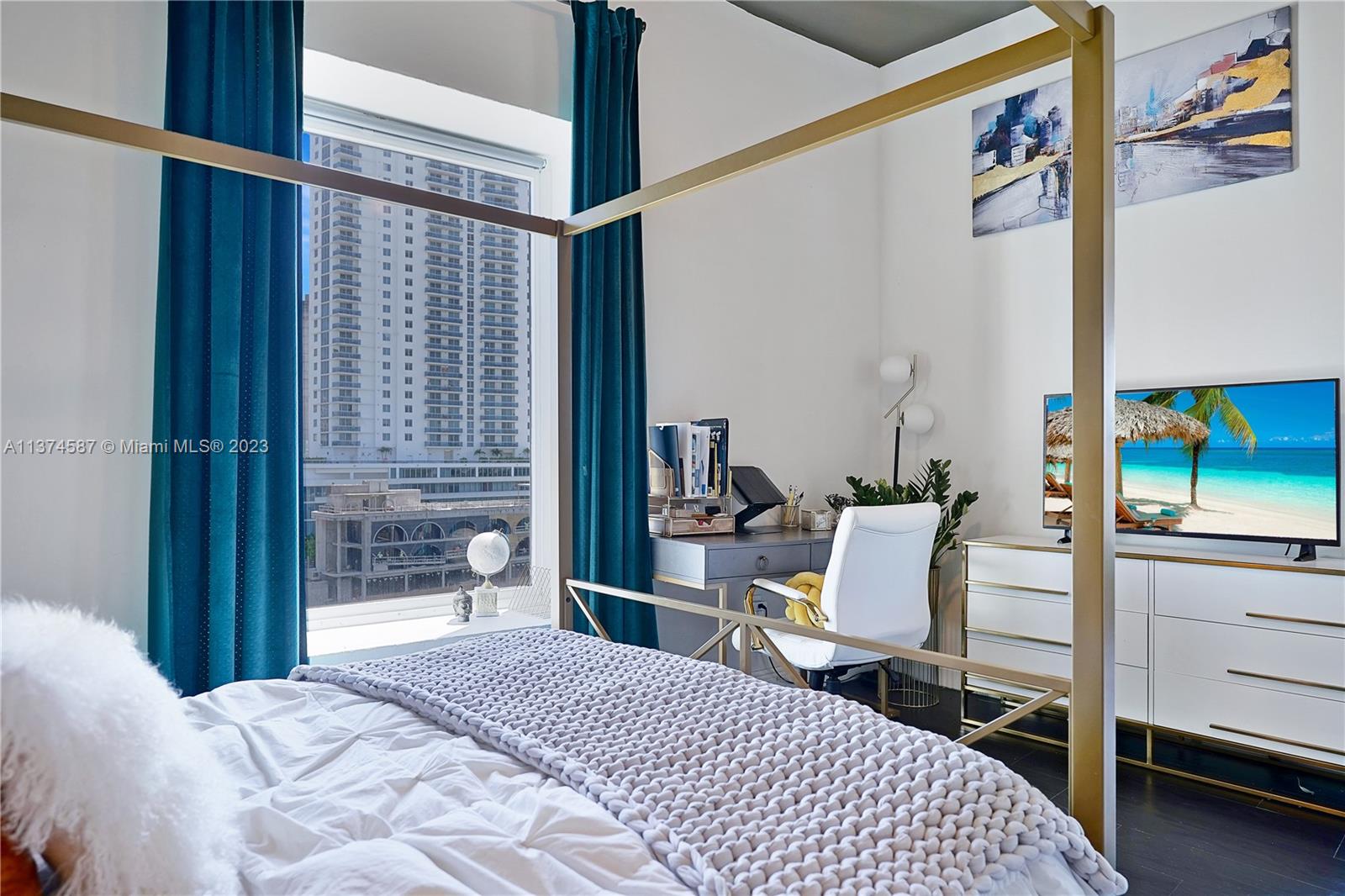 10 Southwest South River Drive, Unit 703 Miami, FL 33130 - Photo 25 of 47 a bedroom with a bed and a mirror