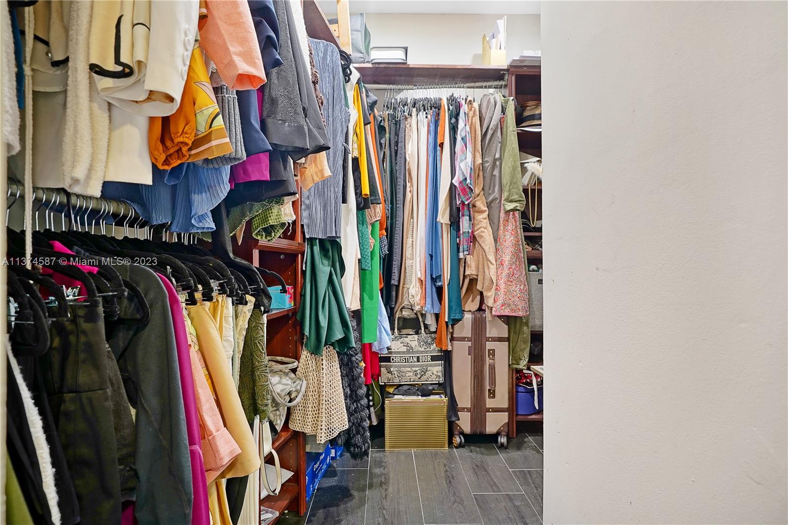 10 Southwest South River Drive, Unit 703 Miami, FL 33130 - Photo 26 of 47 a view of walk in closet with clothes