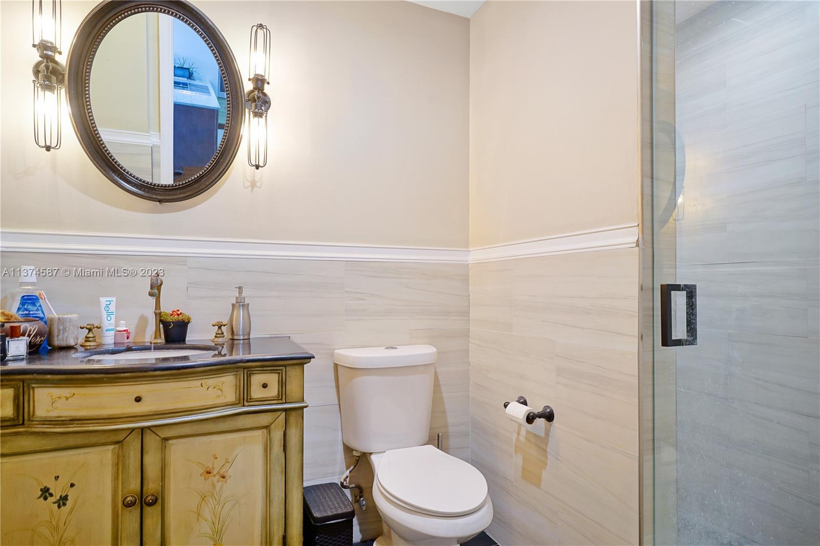 10 Southwest South River Drive, Unit 703 Miami, FL 33130 - Photo 30 of 47 a bathroom with a sink a toilet and a mirror