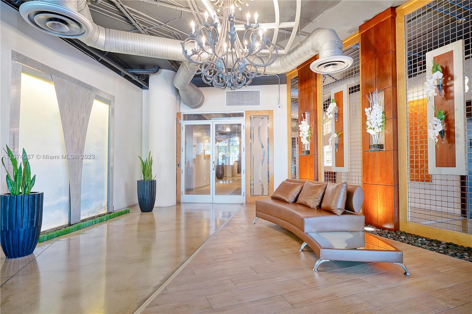 10 Southwest South River Drive, Unit 703 Miami, FL 33130 - Photo 44 of 47 a living room with furniture and a chandelier