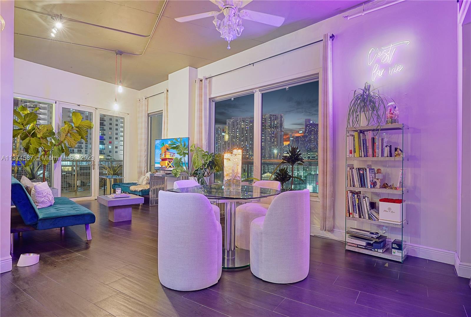 10 Southwest South River Drive, Unit 703 Miami, FL 33130 - Photo 10 of 47 a living room with furniture hard wood floor and a floor to ceiling window