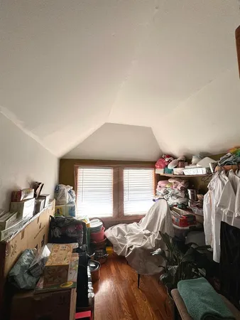 a bedroom with furniture and a window