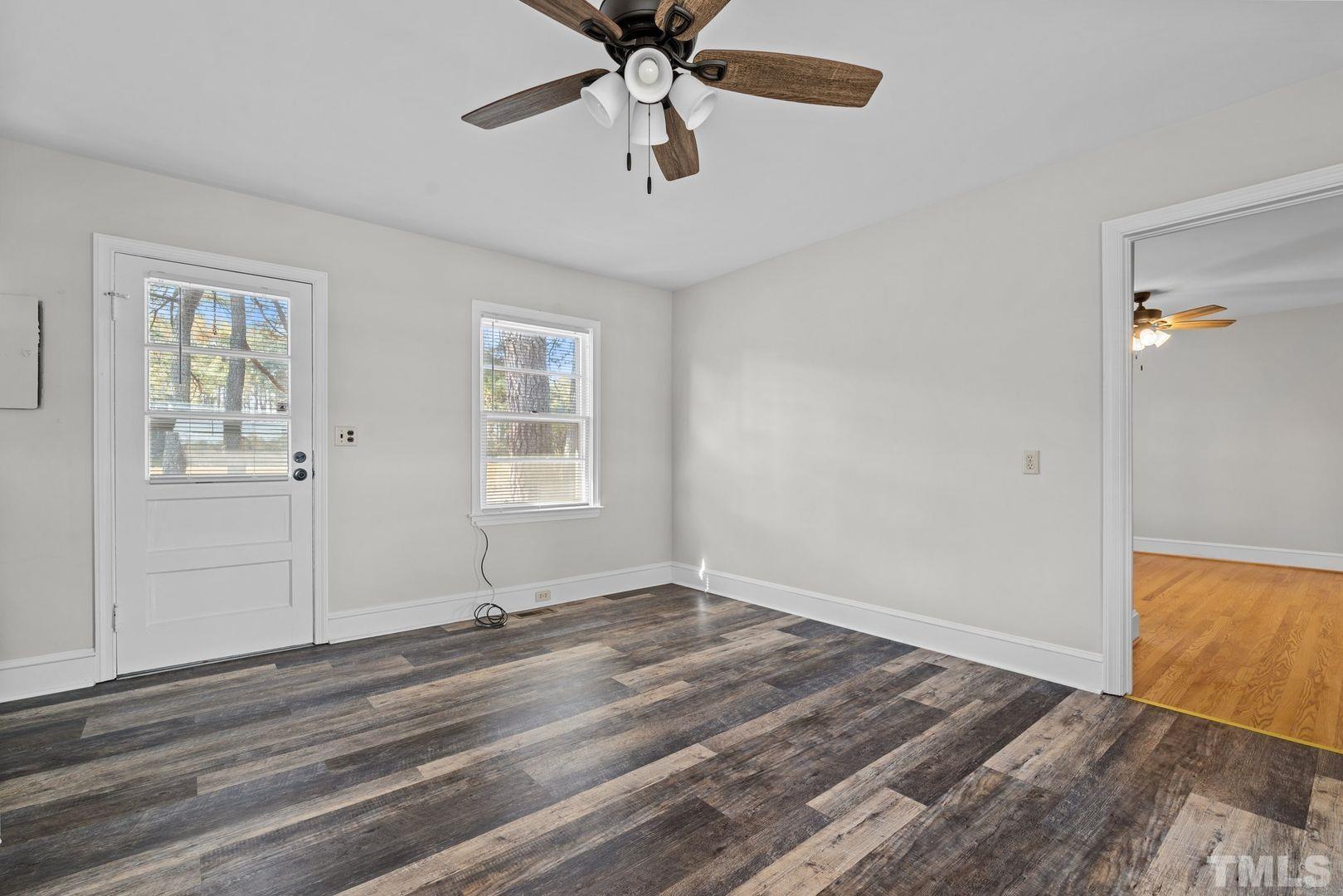 6198 Highway 401 Bunnlevel, NC 28323 - Photo 11 of 33 a view of empty room with wooden floor and fan