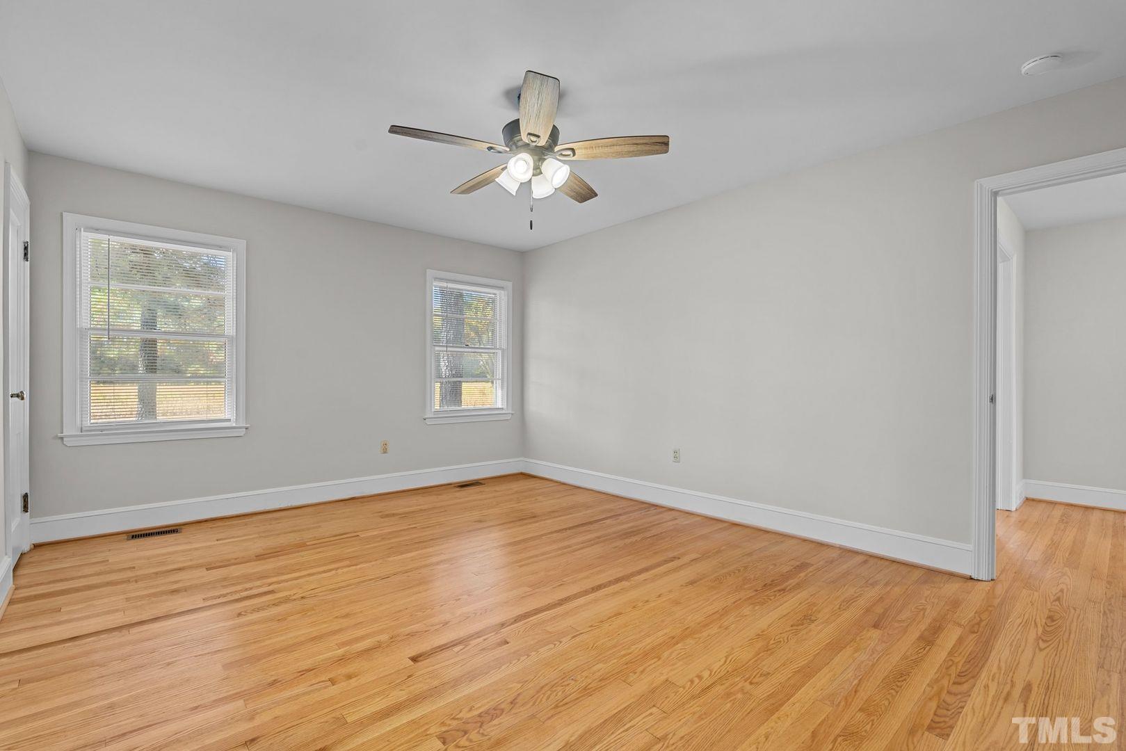 6198 Highway 401 Bunnlevel, NC 28323 - Photo 12 of 33 a view of an empty room with wooden floor and a window