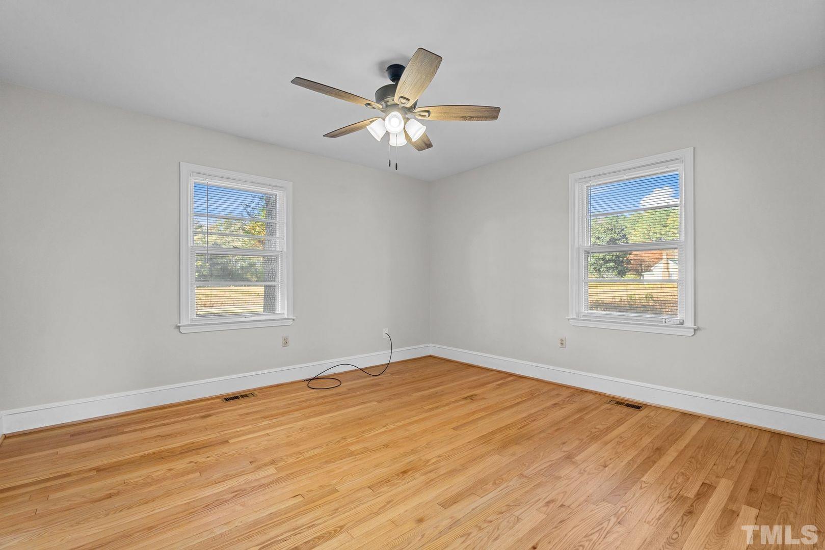 6198 Highway 401 Bunnlevel, NC 28323 - Photo 14 of 33 a view of an empty room with wooden floor and a window