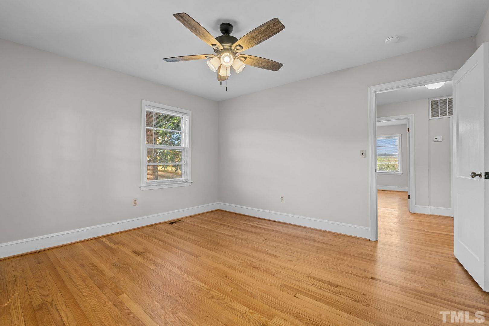 6198 Highway 401 Bunnlevel, NC 28323 - Photo 15 of 33 an empty room with wooden floor and windows