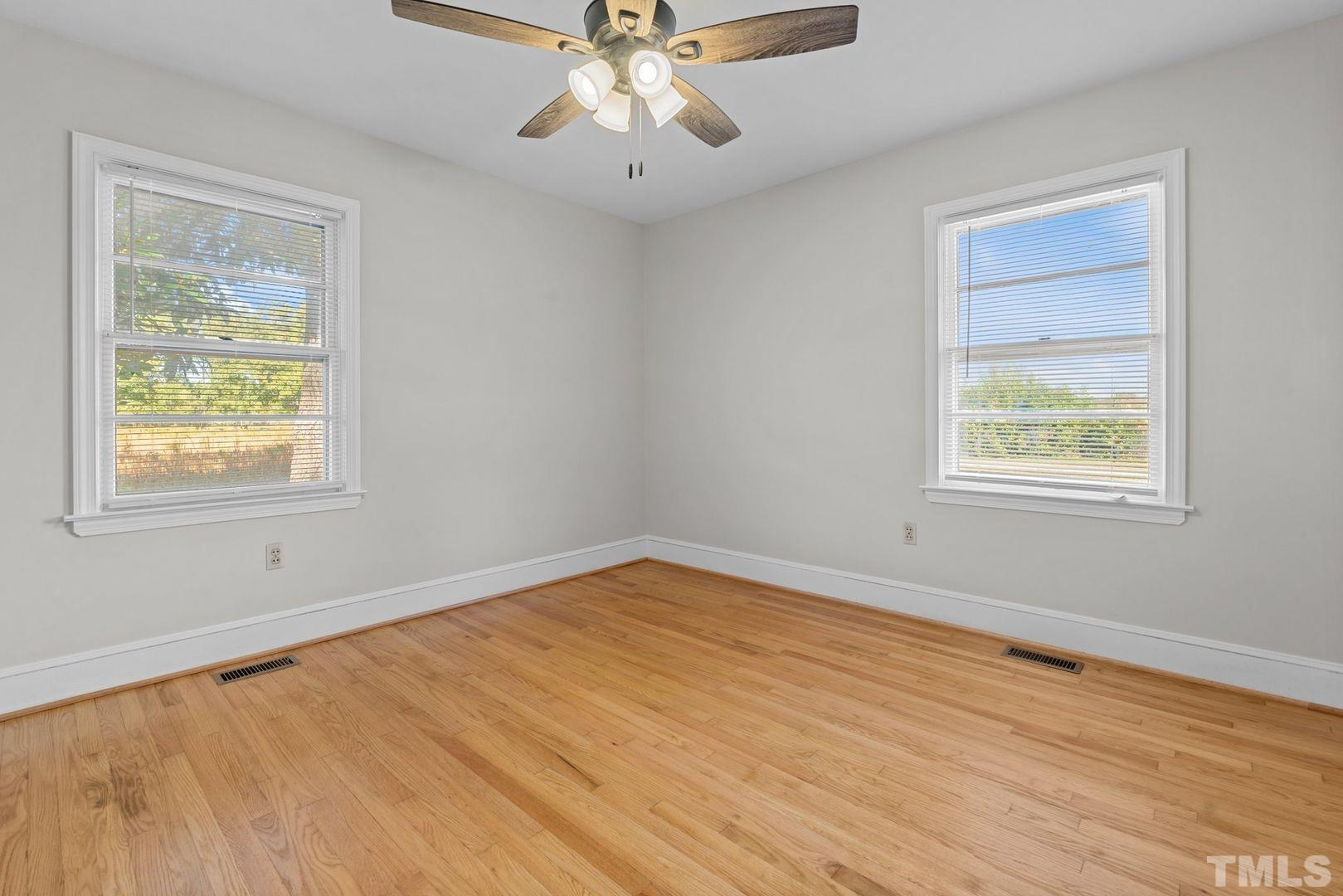 6198 Highway 401 Bunnlevel, NC 28323 - Photo 17 of 33 a view of an empty room with wooden floor and a window