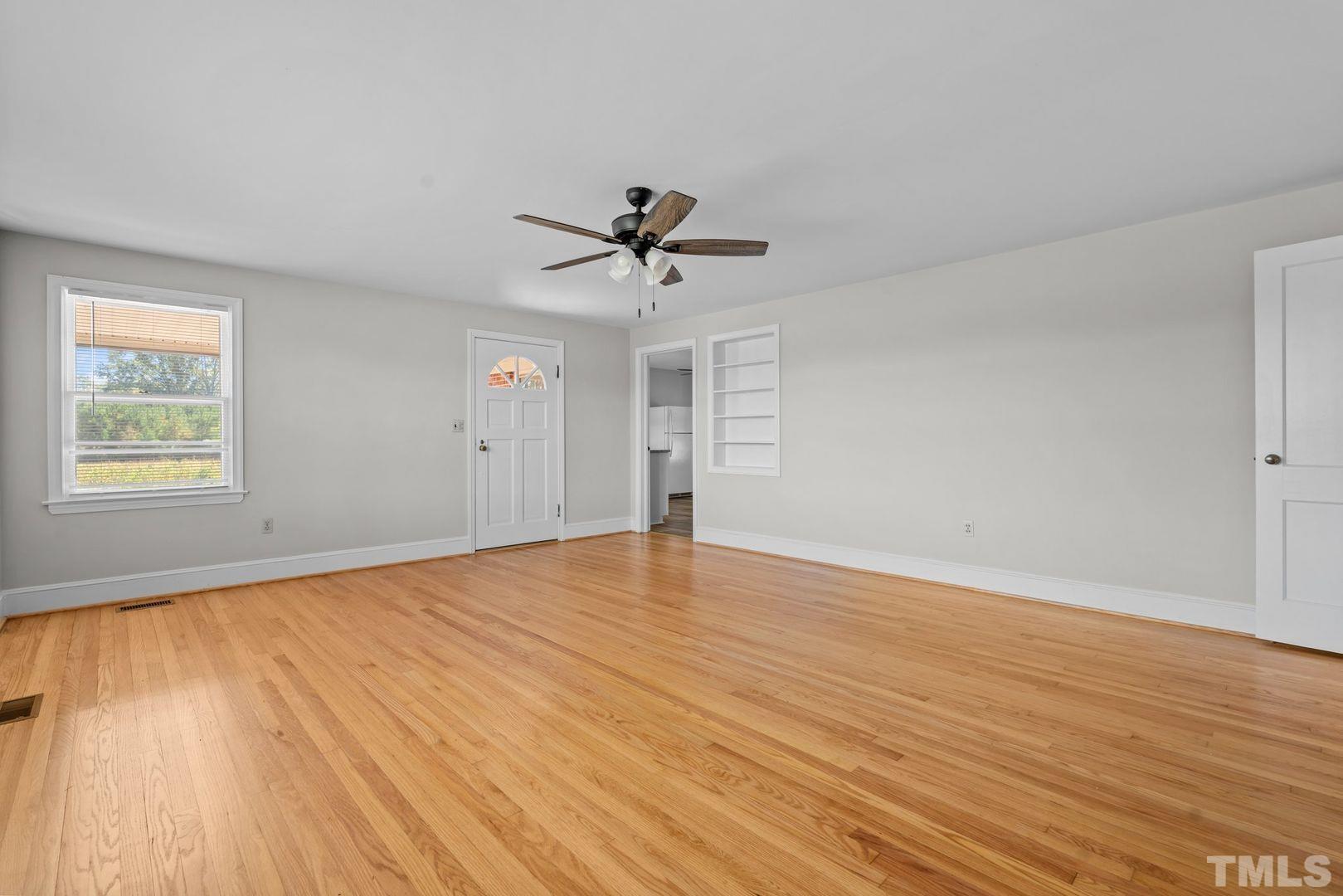 6198 Highway 401 Bunnlevel, NC 28323 - Photo 21 of 33 an empty room with wooden floor and ceiling fan
