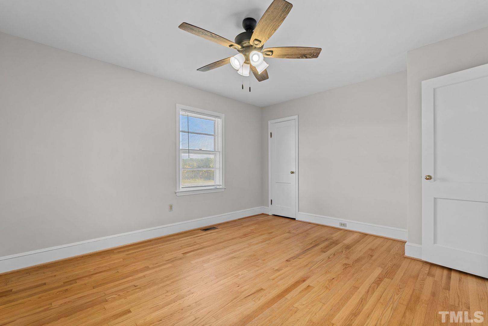 6198 Highway 401 Bunnlevel, NC 28323 - Photo 27 of 33 wooden floor in an empty room with a window