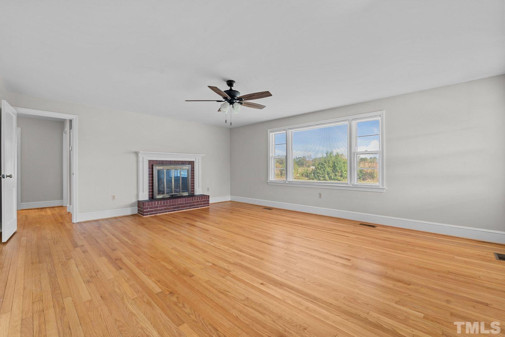 6198 Highway 401 Bunnlevel, NC 28323 - Photo 3 of 33 a view of an empty room with a window and wooden floor