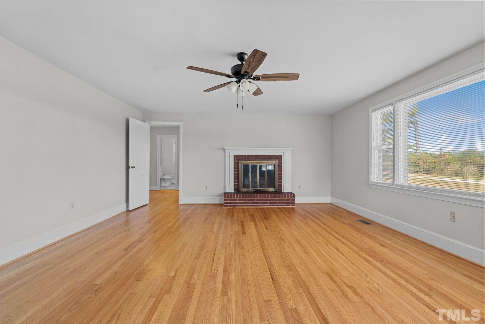 6198 Highway 401 Bunnlevel, NC 28323 - Photo 4 of 33 a view of empty room with wooden floor and fan