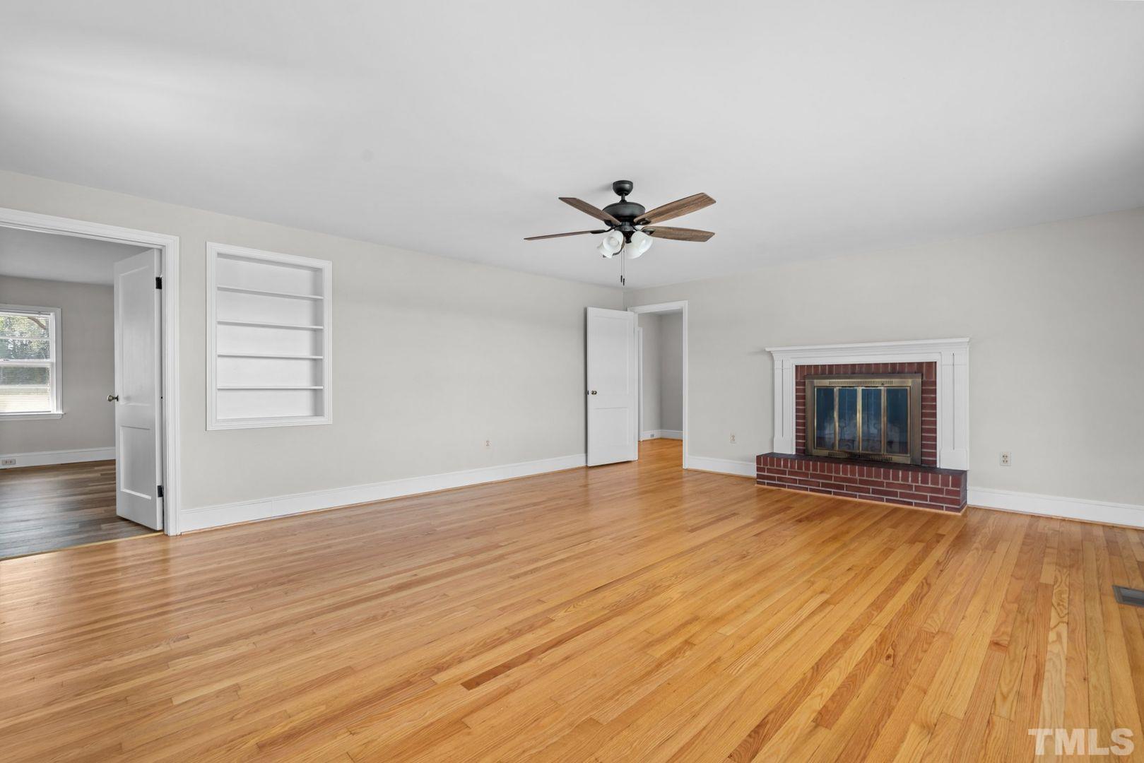 6198 Highway 401 Bunnlevel, NC 28323 - Photo 5 of 33 a view of empty room with wooden floor and fan