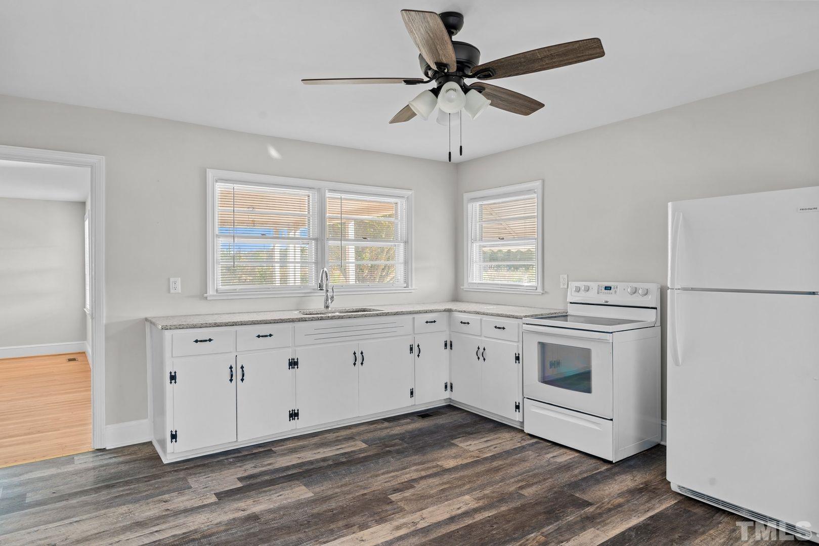 6198 Highway 401 Bunnlevel, NC 28323 - Photo 7 of 33 a view of a kitchen with stainless steel appliances granite countertop white cabinets and a granite counter tops