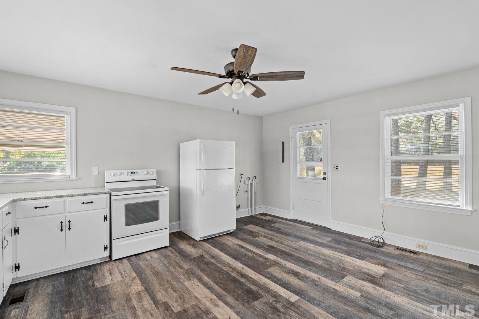 6198 Highway 401 Bunnlevel, NC 28323 - Photo 9 of 33 a view of a kitchen with a stove cabinets and wooden floor