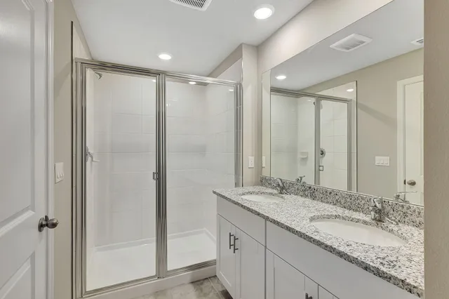a bathroom with a granite countertop sink mirror and double