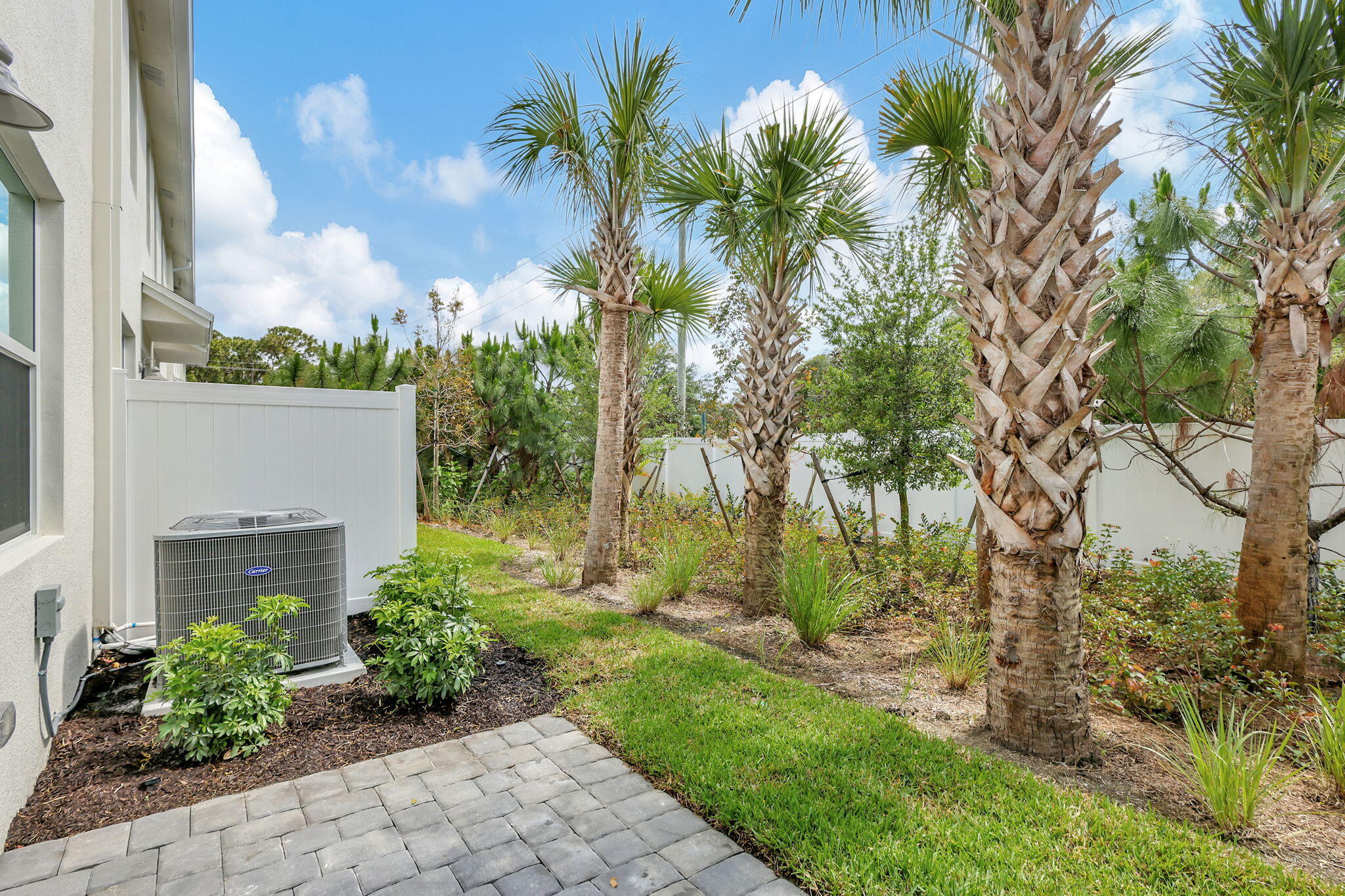 5694 Southeast Edgewater Circle Stuart, FL 34997 - Photo 20 of 22 a front view of a house with a yard and potted plants