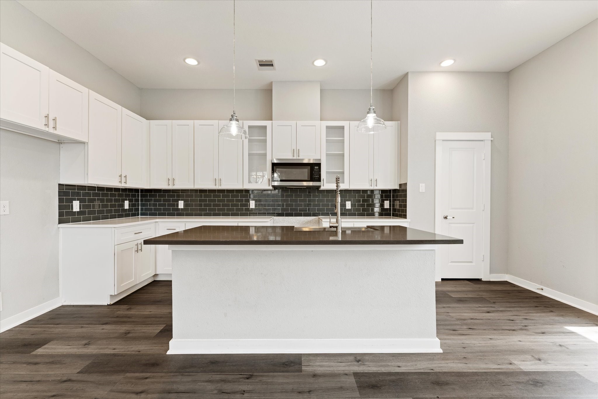 802 Berry Sage Lane Houston, TX 77022 - Photo 7 of 26 Center island kitchen with white cabinetry, ample storage and counter space