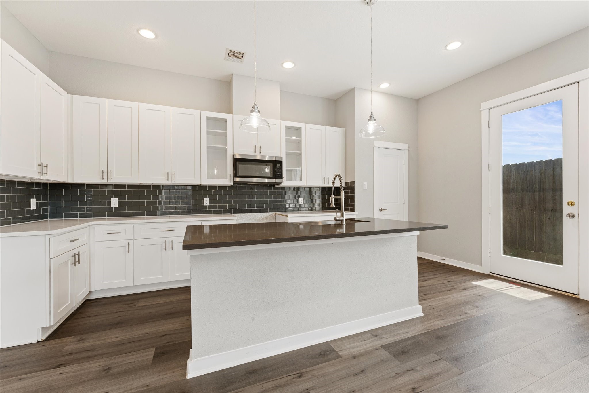 802 Berry Sage Lane Houston, TX 77022 - Photo 8 of 26 Walk-in pantry and access to the backyard from the kitchen