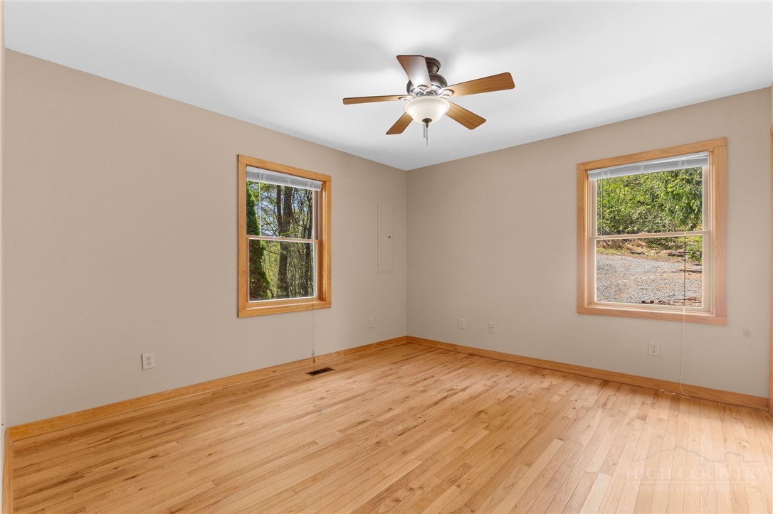 148 Woodby Ridge Road Vilas, NC 28692 - Photo 21 of 33 a view of an empty room with wooden floor and a window