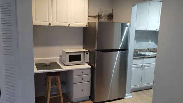a kitchen with stainless steel appliances a refrigerator and cabinets