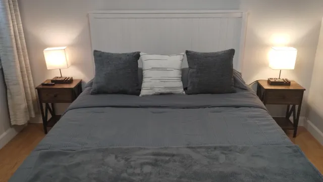 a large bed sitting in a bedroom next to a lamp