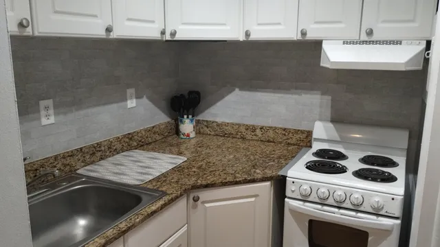 a kitchen with a stove and a sink