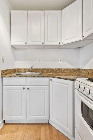 a kitchen with granite countertop white cabinets and a granite countertops