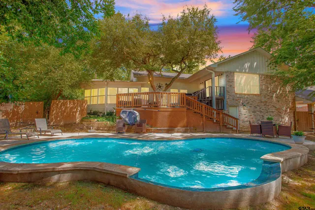 a view of a house with swimming pool and a yard
