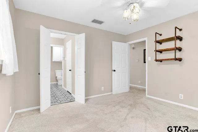 an empty room with windows and cabinet