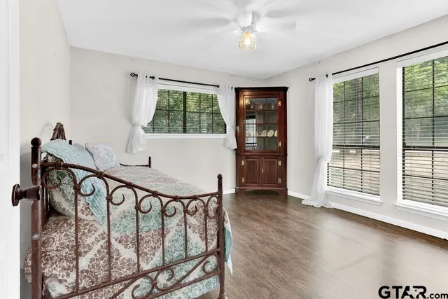 a bathroom with a sink a toilet and a large mirror