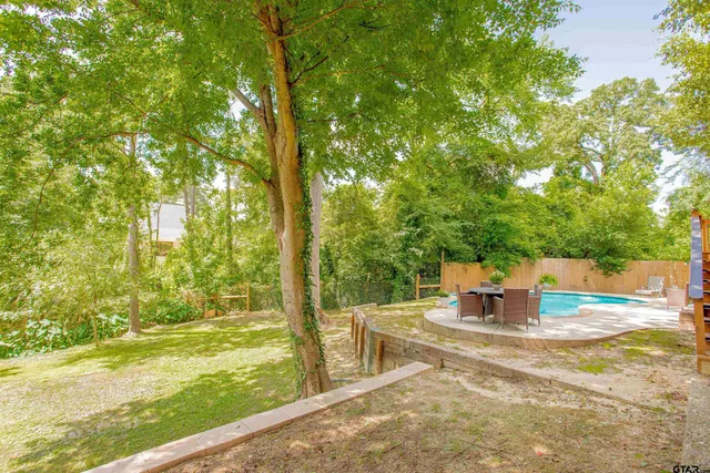 a street sign on a sidewalk next to a road