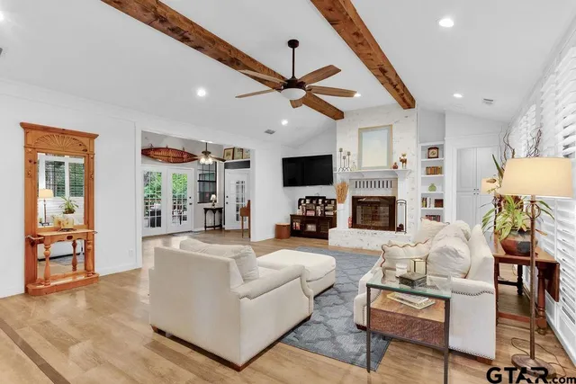 a living room with fireplace furniture and a flat screen tv