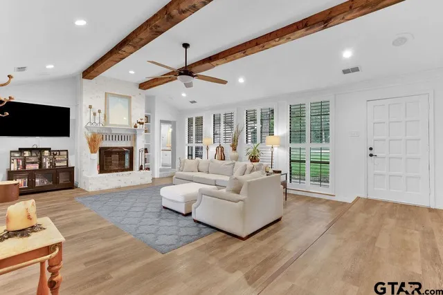 a living room with fireplace furniture and a flat screen tv