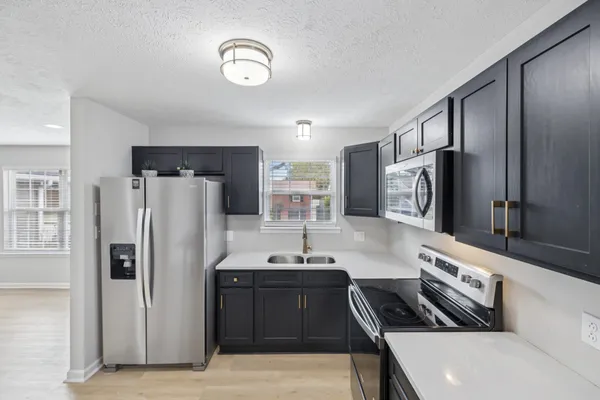 a kitchen with stainless steel appliances a refrigerator and a sink