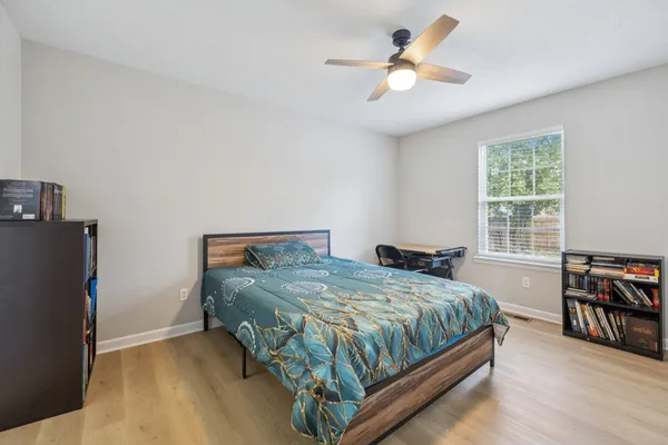 a bedroom with a bed and a chandelier