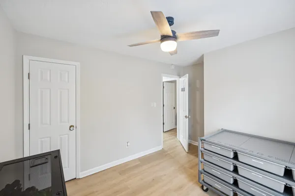 a view of an empty room and wooden floor