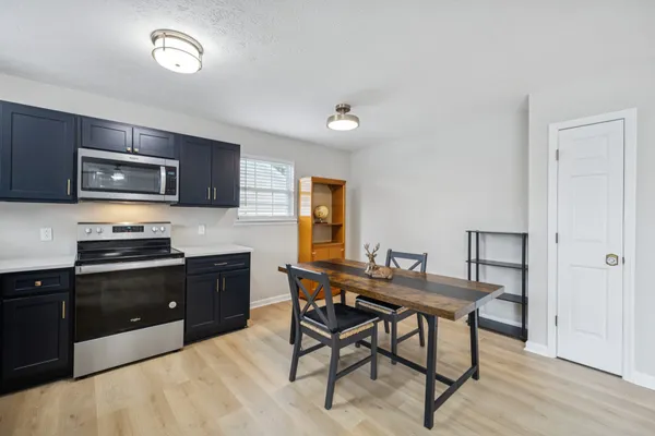 a kitchen with a table and chairs in it