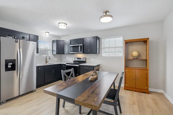 a kitchen with stainless steel appliances a refrigerator stove microwave and sink