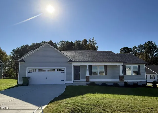 a view of a house with garden and yard