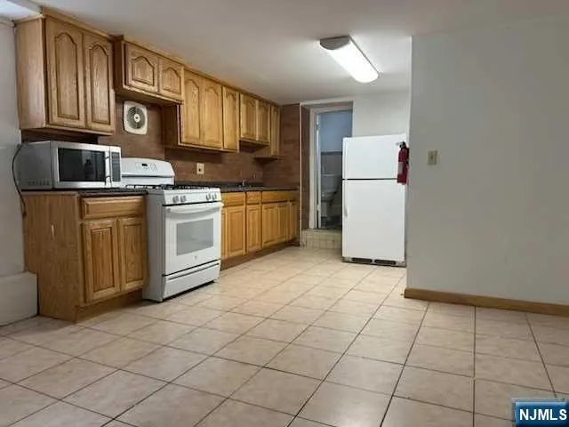 a kitchen with a refrigerator sink and cabinets