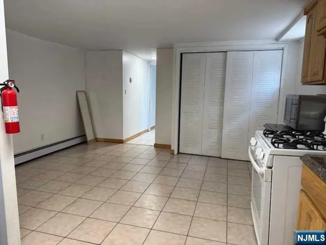 a kitchen with a refrigerator and a stove top oven