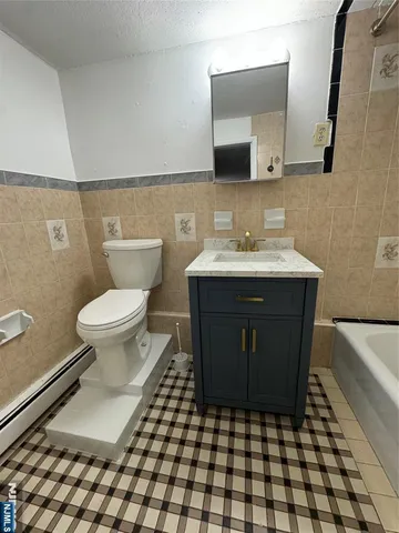 a bathroom with a sink toilet and mirror