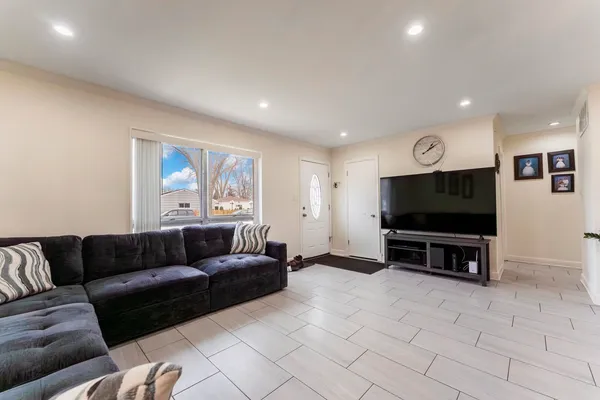 a living room with furniture and a flat screen tv