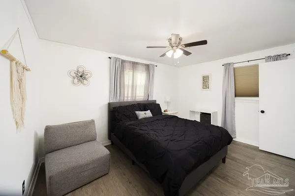 a bedroom with a bed couch and window