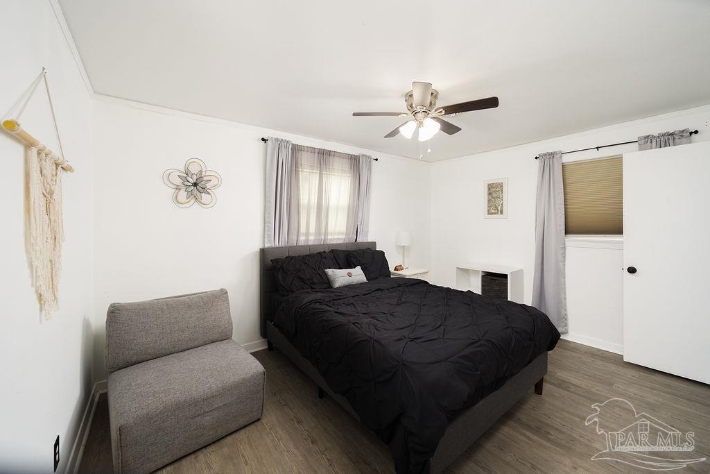 6841 Data Street Pensacola, FL 32504 - Photo 13 of 25 a bedroom with a bed couch and window