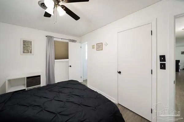 a bedroom with a bed and a chandelier