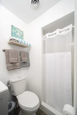 a white toilet sitting next to a bathroom sink