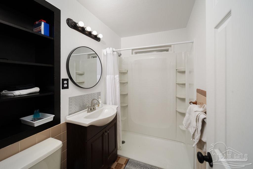 6841 Data Street Pensacola, FL 32504 - Photo 18 of 25 a bathroom with a sink toilet and a mirror