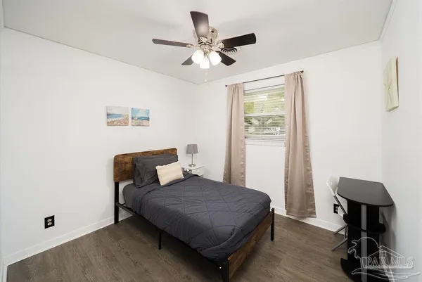 a bedroom with furniture and a window